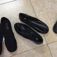 Load image into Gallery viewer, A pair of black size 9 leather jazz dance shoes resting on a tiled floor.