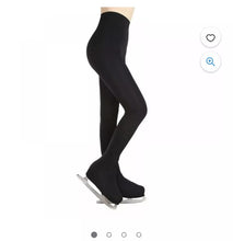 Load image into Gallery viewer, A side profile view of a person wearing black footed tights with ice skates.