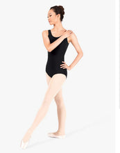 Load image into Gallery viewer, A ballerina standing in a graceful pose wearing a classic black tank leotard and dance tights on a plain white background.
