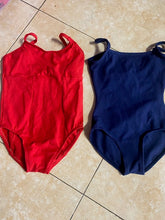 Load image into Gallery viewer, Ek halki gulabi farsh par rakhi hui laal (crimson) aur gehre neele (navy) rang ki spaghetti strap wali dance leotards ka sangrah.