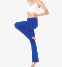 Load image into Gallery viewer, Ek dancer ne white crop top ke saath royal blue rang ki flared dance pants (jazz pants) pehni hui hai aur woh dance pose mein khadi hai.