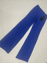 Load image into Gallery viewer, A pair of royal blue flared jazz or dance pants laid flat against a white background.