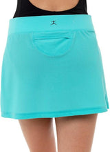 Load image into Gallery viewer, The back view of a turquoise dance skirt featuring a wrap-style design, worn over a black leotard.