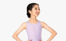 Load image into Gallery viewer, A young dancer with her hair in a braided updo, smiling while wearing a lavender tank-style leotard, isolated against a white background.